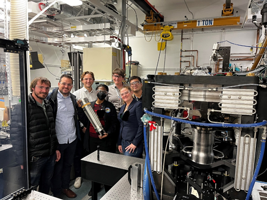People stand in a lab smiling at the camera