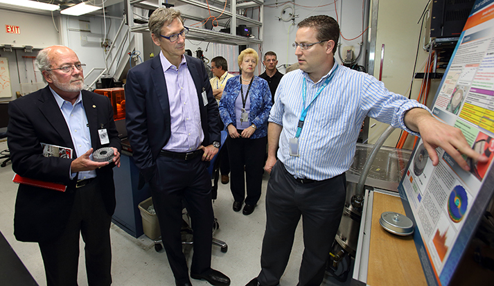 CRF researcher Jeff Koplow, right, explains the Sandia Cooler to Cummins President and CEO Tom Linebarger, on left, and Vice President and CTO John Wall, middle. The pair learned about many Sandia innovations on their visit to the CRF. (Photo by Dino Vournas)