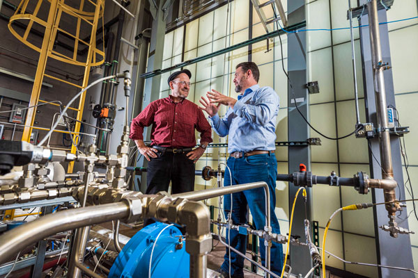 Sandia researcher Bobby Middleton, right, has developed a more efficient cooling system for power plants. Together with Patrick Brady, left, the researchers are also developing a first-of-its kind systems dynamics analysis to identify water-saving technologies for cooling at power plants.