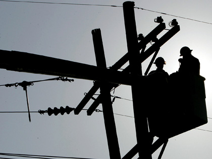a stockphoto of two electricians observing a power line