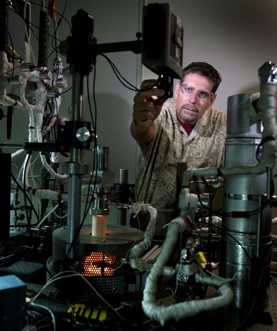 a researcher adjusting testing equipment