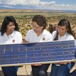 Sandra Begay-Campbell, a Sandia researcher and member of the Navajo Nation, talks with Sandia interns at the Pueblo of Acoma about how a photovoltaic panel works to generate electricity.