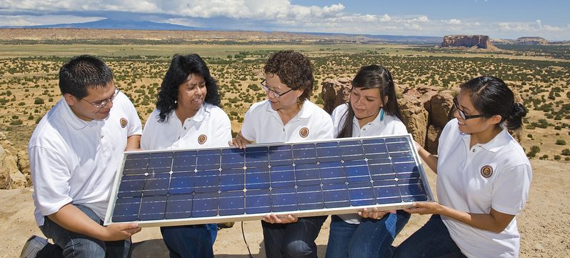 Sandra Begay-Campbell, a Sandia researcher and member of the Navajo Nation, talks with Sandia interns at the Pueblo of Acoma about how a photovoltaic panel works to generate electricity.