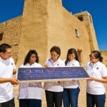 Sandra Begay, center, talks with interns about how a photovoltaic panel works to generate electricity. The DOE has offered the internship program through Sandia since 2002. Picture taken at the Mission San Esteban Rey in the Pueblo of Acoma. Photo credit: Randy Montoya