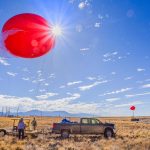Dari Dexheimer, Sandia National Laboratories’ tethered-balloon expert, and her team prepare the 22-foot-wide, tethered, helium balloons for launch on a gorgeous fall morning. (Photo by Randy Montoya)