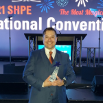 Image of Ken Armijo at the ceremony holding the SHPE STAR award.