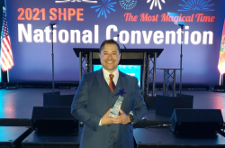 Image of Ken Armijo at the ceremony holding the SHPE STAR award.