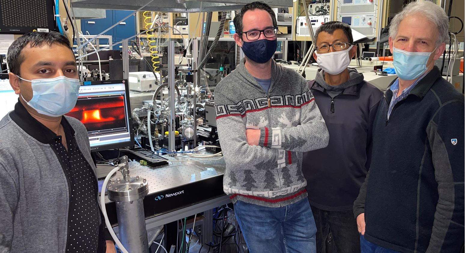 From left, Malik Tahiyat, from University of South Carolina, and Sandia scientists Dirk van den Bekerom, Erxiong Huang, and Jonathan Frank are all performing experiments in the Plasma Research Facility. Photo by Angie Zhang