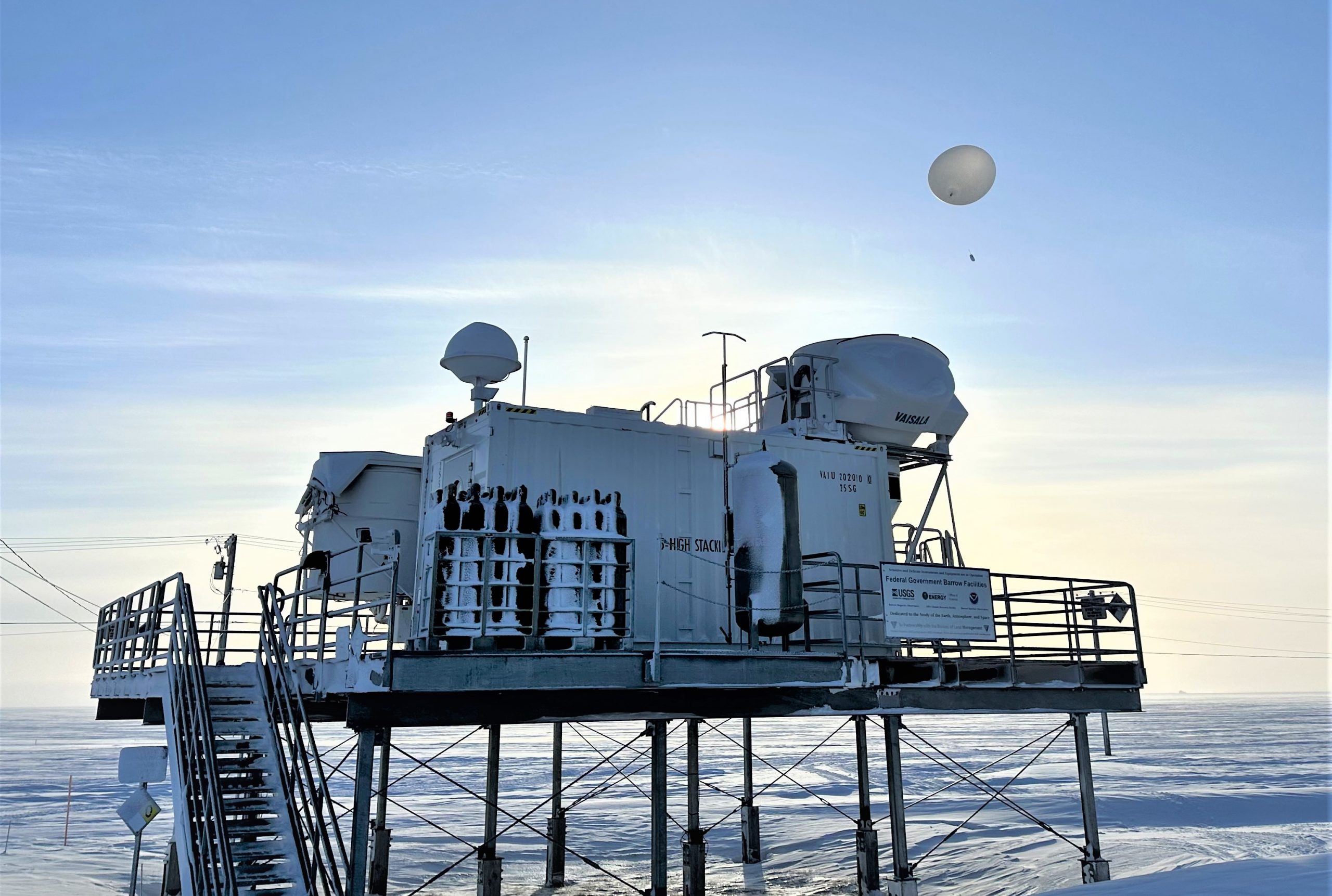 A hydrogen-filled weather balloon launches automatically from a Department of Energy atmospheric measurement facility in Utqiaġvik, formerly known as Barrow. About three years ago, Sandia National Laboratories switched from launching helium-filled balloons to launching hydrogen-filled balloons to reduce costs and carbon emissions. (Photo by Ben Bishop)