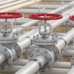 Oil, Gas Or Water Transportation With Pipe Line Valves On Soil With Defocused Background