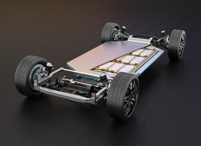 A three-dimensional rendering of an electric vehicle chassis equipped with in-wheel motors and a solid-state battery pack. 