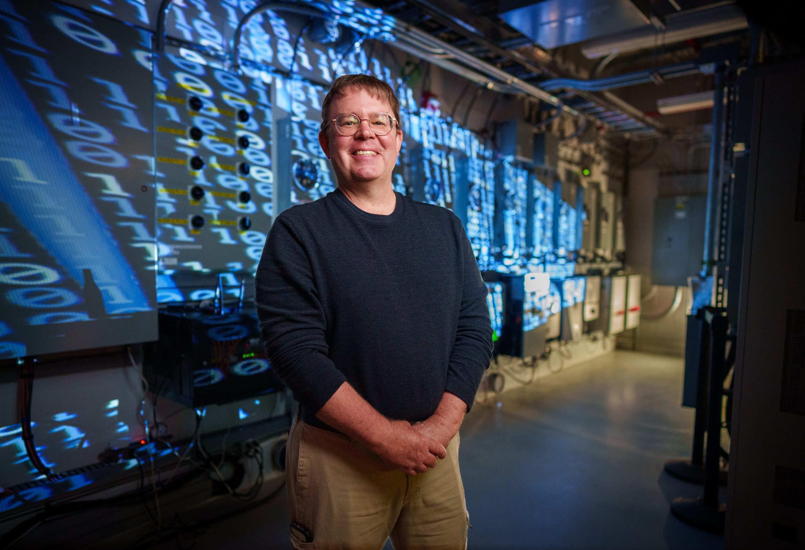 Michael Ropp poses for a photo at Sandia’s Distributed Energy Technology Lab (DETL) on Oct. 13, 2023. His team is working on ways for an energy microgrids to self-heal using computer algorithms. Photo by Craig Fritz/Sandia National Labs