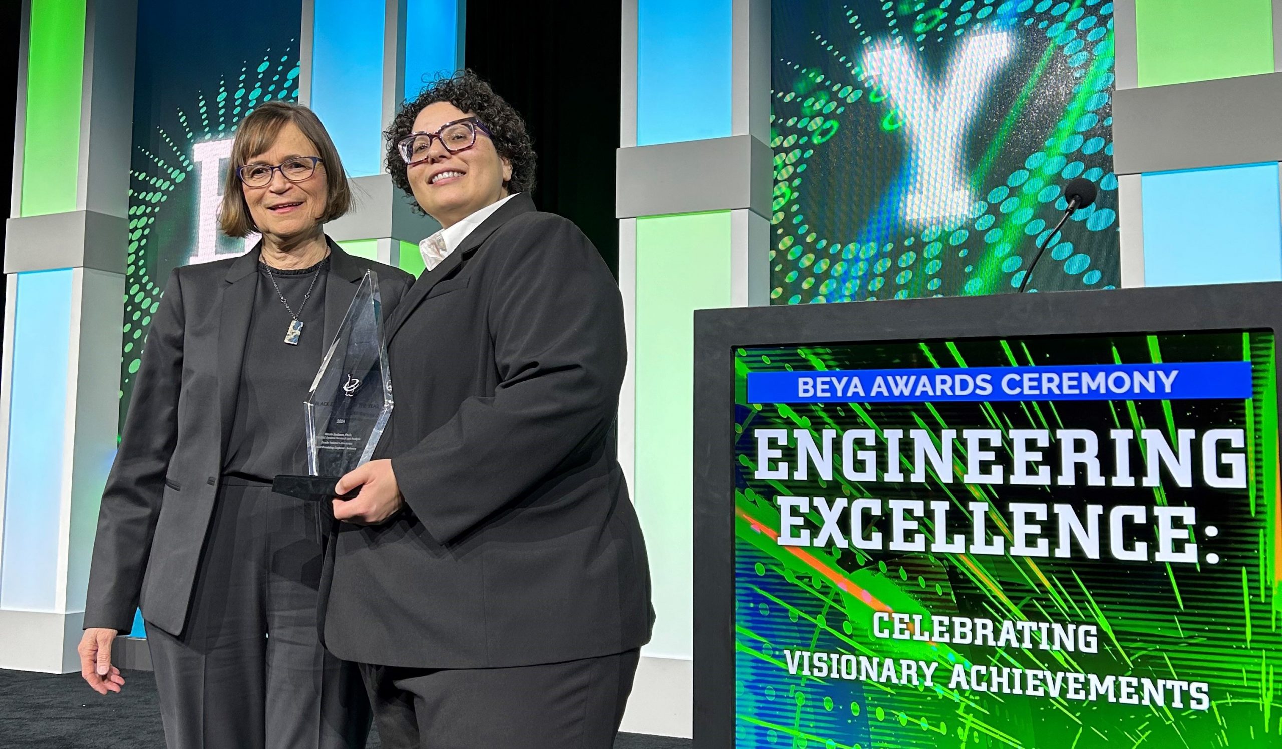 Stephanie Kuzio and Nicole Jackson pose with Nicole's award at the Black Engineer of the Year Award conference