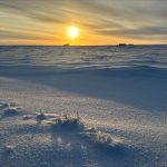 A sunset reflects on snow in the arctic