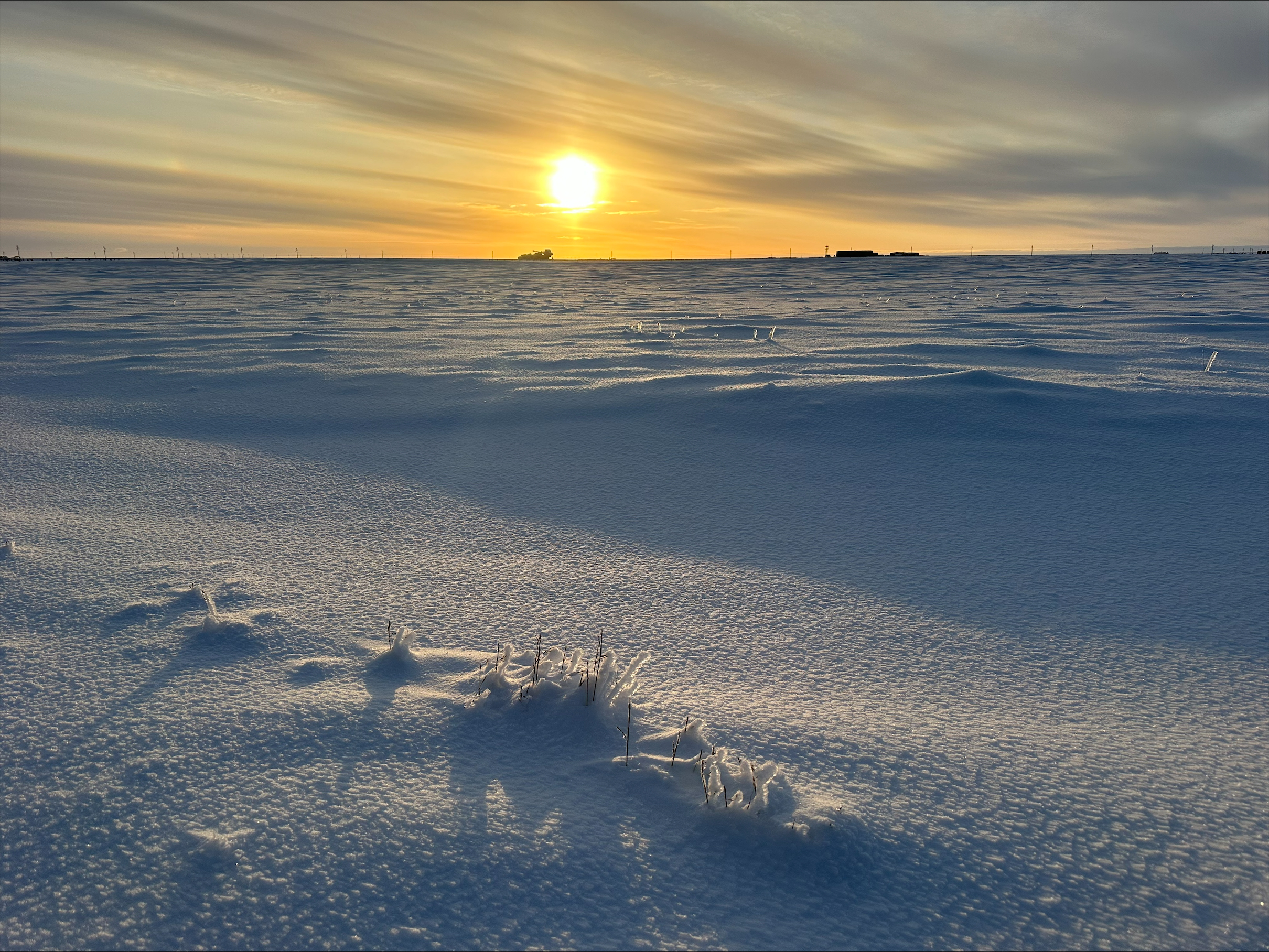 A sunset reflects on snow in the arctic