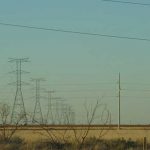 Powerlines against a dark blue sky